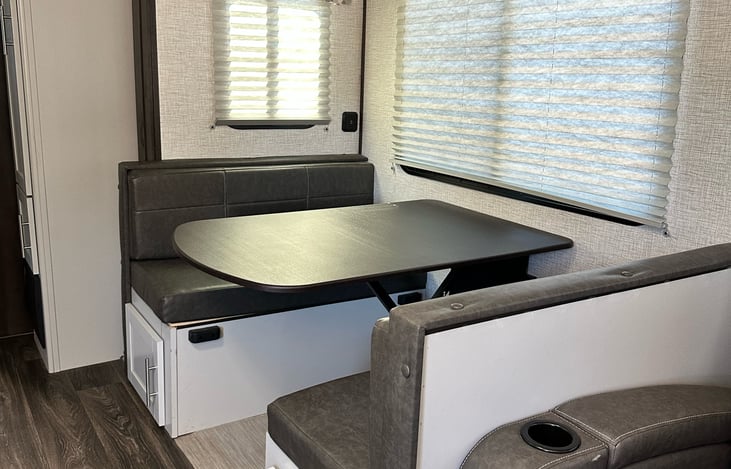 Dinette includes storage and converts to additional sleeping space.