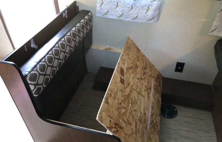 Under the dinning benches is extra storage. Lift the cushion and move the board to gain access. Be sure the board is all the way snug in its place to prevent pinching or damage.