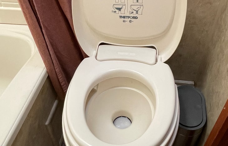 Flush toilet and small stainless steel trashcan.
We do encourage visitors to utilize the campground's vault toilets to stretch the contents of the water tank to last the entire stay.