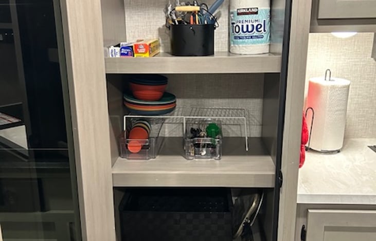 Spacious pantry stocked with foil, wrap & extra dinnerware