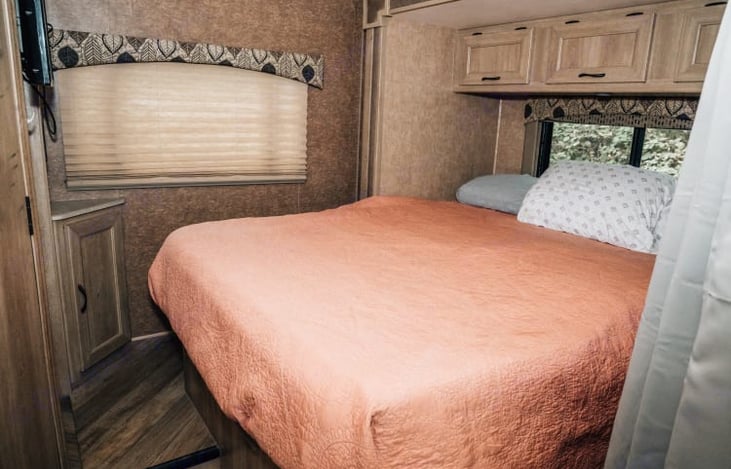 Queen bed in rear with slide out.