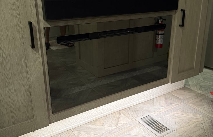 Fireplace with remote. Can change flame color and run without heat just for the fireplace glow! 
Above it, a Bluetooth speaker that can be played inside the RV and on the outside speakers!