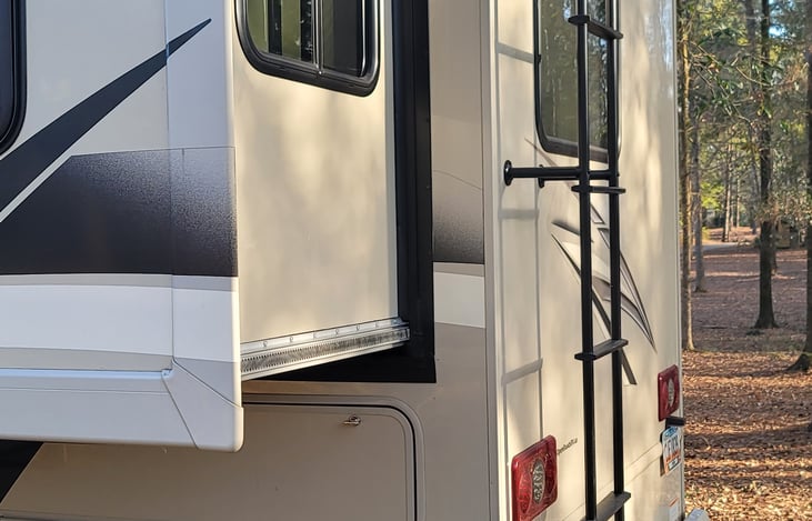 Rear of the camper with roof ladder.