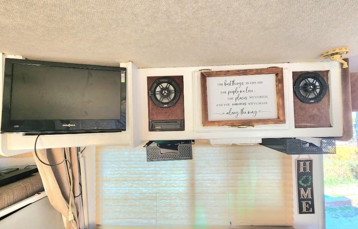 This tv comes outwards and can swivel from left to right. The black containers hold the dvd player and remove, keys, cords.