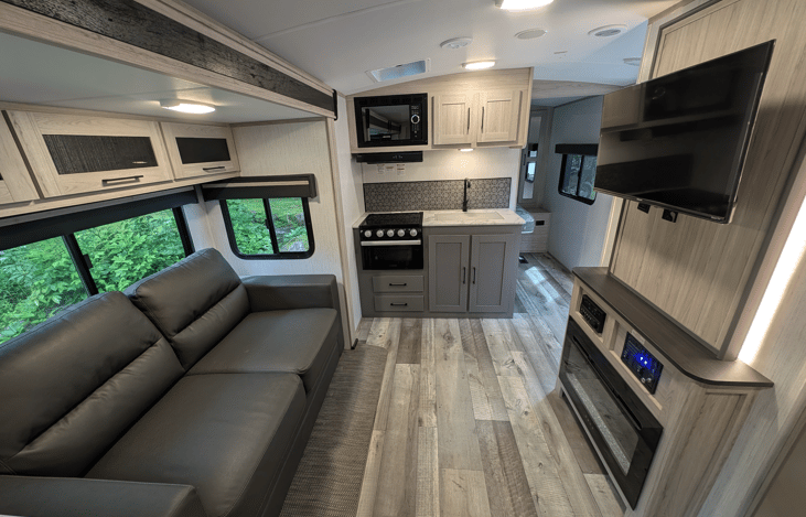 Spacious and accommodating interior with smart TV, fireplace, music system, comfy couch, large dinette, full bathroom, large refrigerator, kids bunkhouse and more.