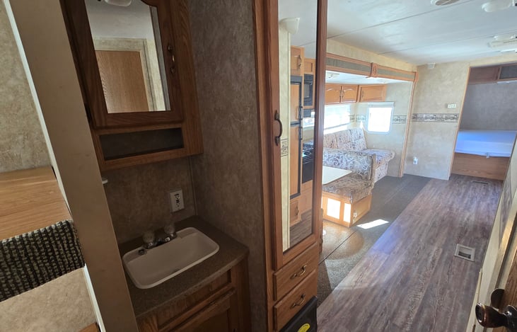 Bathroom sink is outside of toilet and shower area so its more accessable to multiple people.