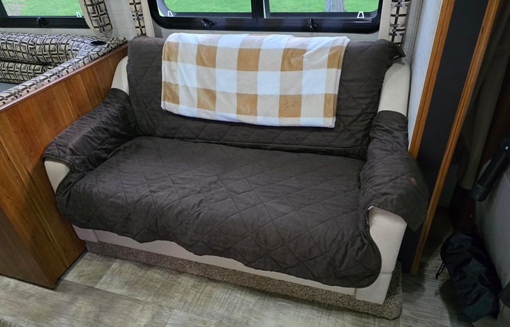 Loveseat folds down to small twin bed