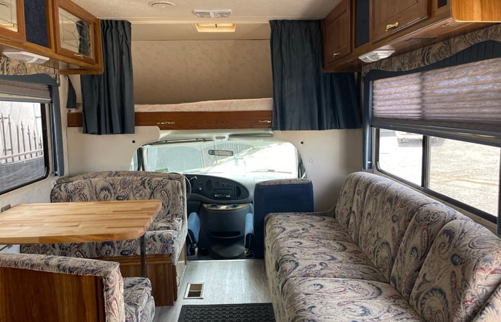 Left dinette converts to one bed. Couch on right folds out for another. Above cab is ideal for two children or one adult.