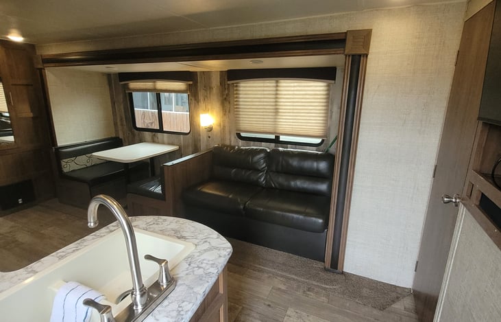 usb charging port on wall next to the sofa/convertable bed.  Table converts to bed also