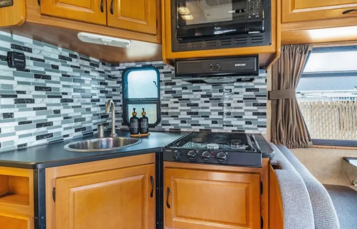 Modern RV kitchen with full appliances — cook meals while camping in the Southwest, from Zion to the Grand Canyon or while parked at Burning Man.