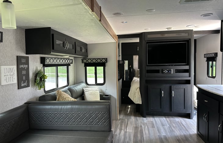 The swivel TV can be watched from the living room or master bedroom. There are privacy doors for the master bedroom with a queen size bed.