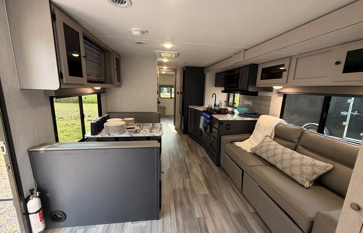 Spacious Living area with Dinette recliner and jackknife couch large kitchen, TV.