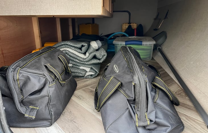 Pass through outdoor access storage - outdoor mat, broom, hoses, levelers, and tools.