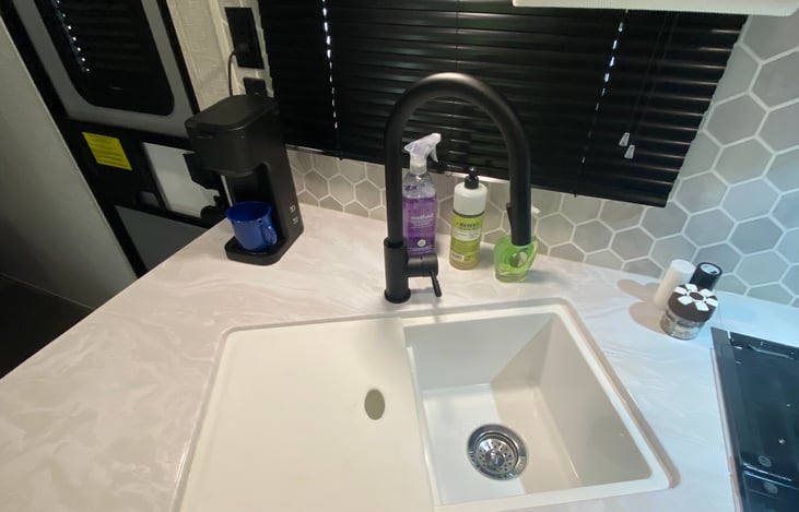 2 compartment sink with cover that doubles as a cutting board.  Extra cutting board included as well.