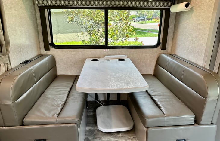 Cozy dining area with lap seatbelts on both side and a charging station in the center for your wireless devices. Table collapses to create additional sleeping space for your smaller travelers!