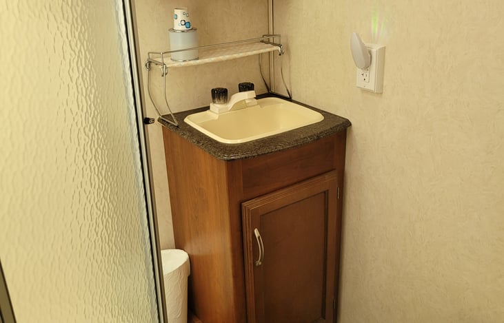 Bathroom is right off the end of the bedroom. 
It has a shower, sink, mirrored cabinet & toilet.