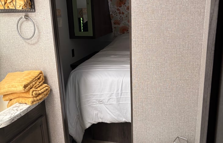 View of bedroom from door in hall so that guests do not have to go into bedroom to use facilities.