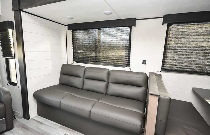 Sofa bed with fold down cup holders and storage underneath