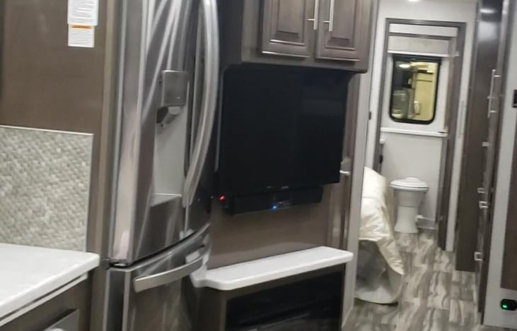 TV above the fireplace, across from the captain chairs.  (Recliners).