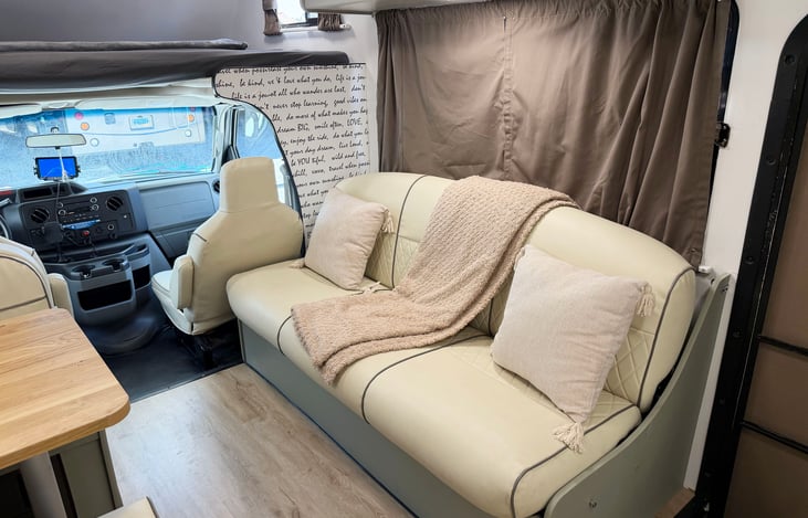 Cozy RV sofa with pillows & soft throw blanket – comfortable space to relax after your adventure