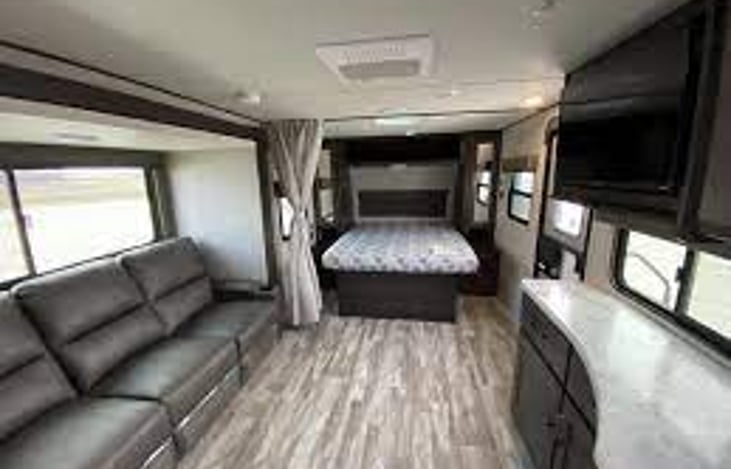 Living area and full queen size bed.  Additional storage below foot of the bed.