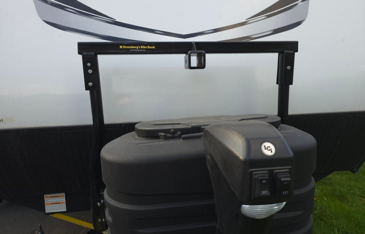 Dual propane tanks, powered jack with light, front bike rack with 2" hitch.  BYO bike rack and Bikes (not liable for any damages to your own equipment)