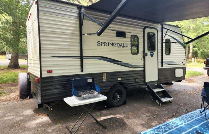 RV has an awning with LED lighting and also comes with an outdoor propane stove