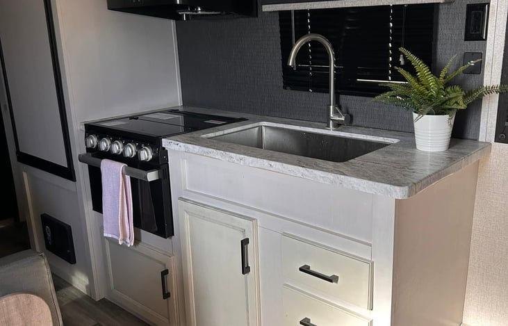 Kitchen with 3 burner stove, oven and microwave (full hookups only)