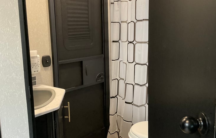 Bathroom view showing exterior rear door entrance.