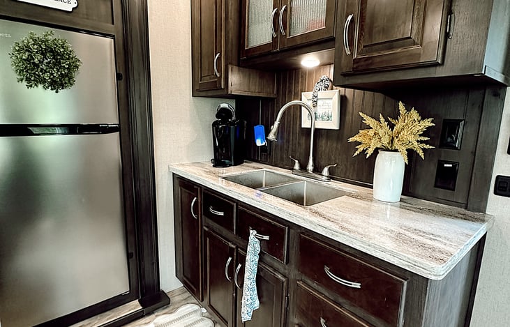 Camper comes with cute rugs, artwork, and more to make it feel more like a residential rental, than a camper.