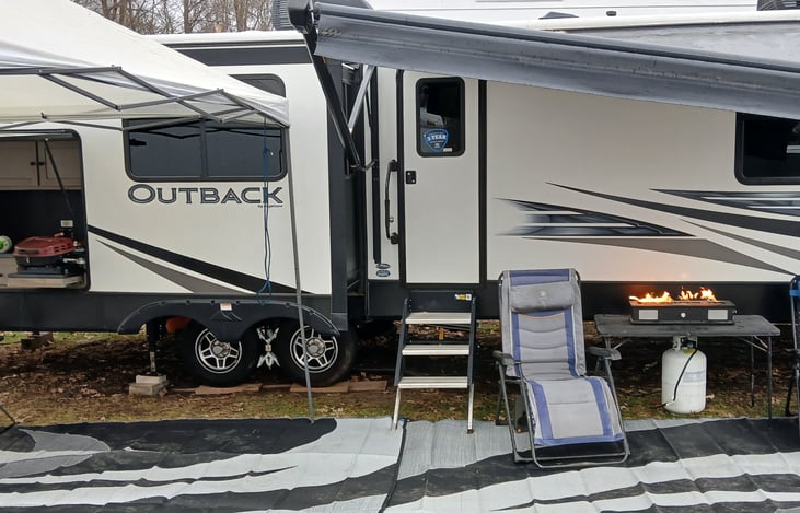 The luxury camp setup. You will be provided with 2 zero gravity chairs  2 outside trash cans. Rugs that run whole length of camper.canopy for over outdoor kitchen. A plastic table.