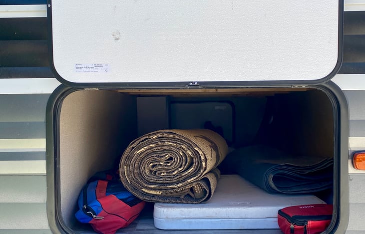 Storage, outdoor mat, folding table and camping chairs