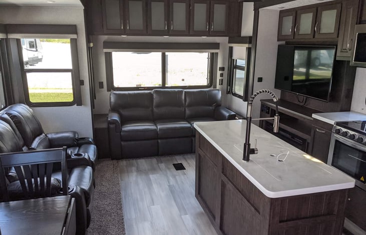 Large spacious floor plan couch recliners dinning room table tv kitchen island