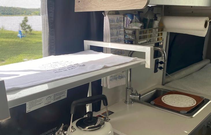 Our kitchen, where all the meal-time magic happens. With added storage and a place for the toaster oven, which we stow during driving.