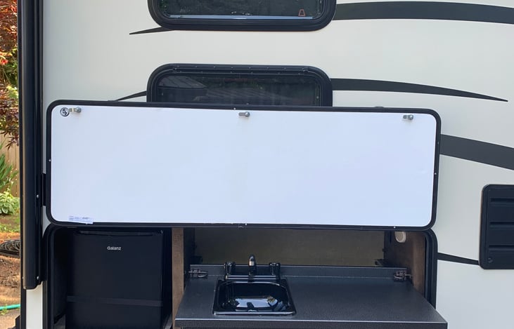 Outdoor sink with counter and mini fridge