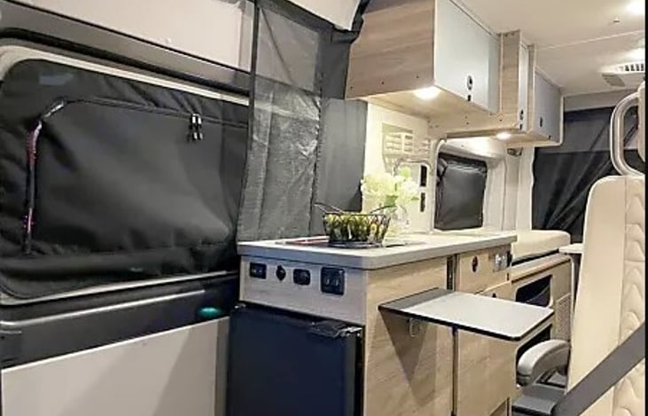Kitchen includes small fridge and freezer, 2 burner stove top, kitchen sink, and lots of counter space!