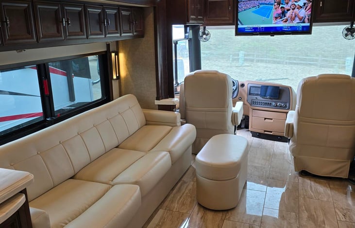 There is another TV in the living area at the front of the bus