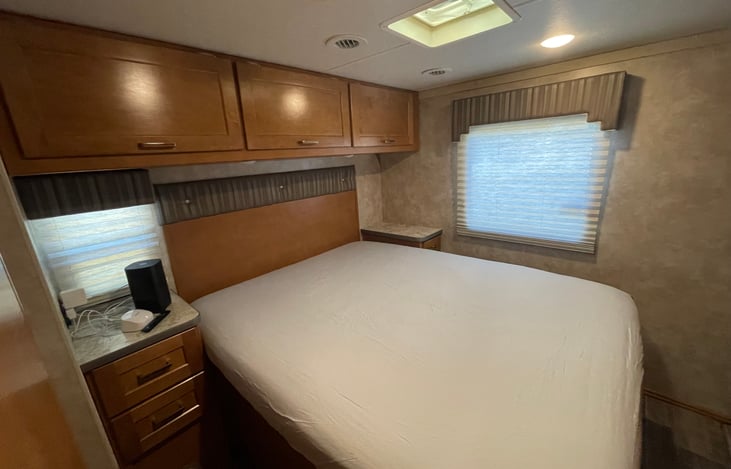 The Bedroom has a queen bed with a bunch of storage. Matching night stands with Drawers