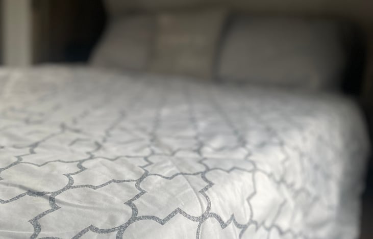 Large private master room with queen bed, TV and storage.