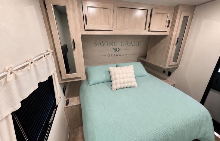 Private primary bedroom offers a peaceful space to unwind with convenient storage for your belongings.