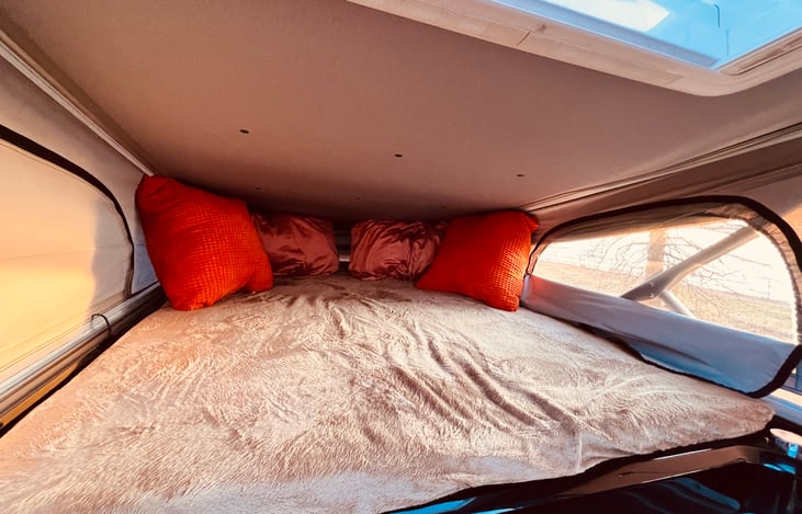 Pop-up bunk bed. Can fit 2 adults.