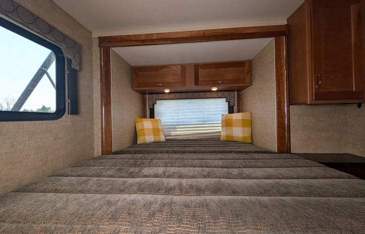 Cozy queen bed in the back with a slide-out closet and plenty of storage.