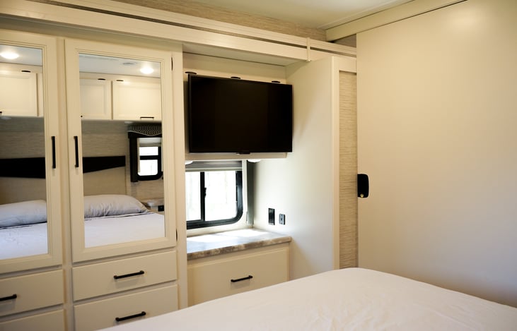 master bedroom features its own tv and spacious closet