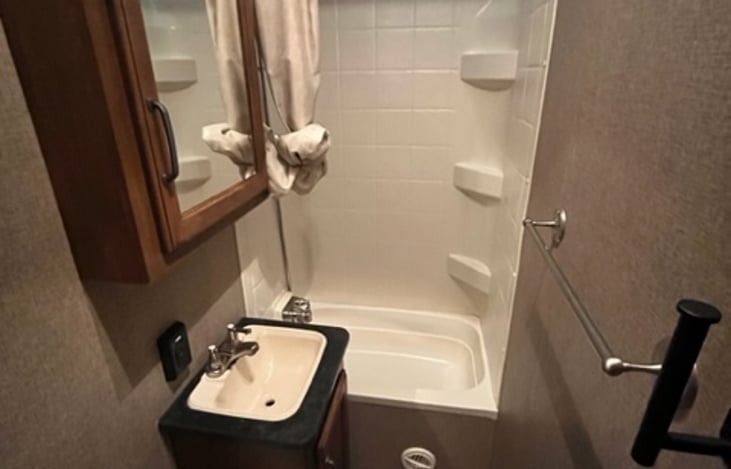 Full bath with tub/shower, sink, and toilet!