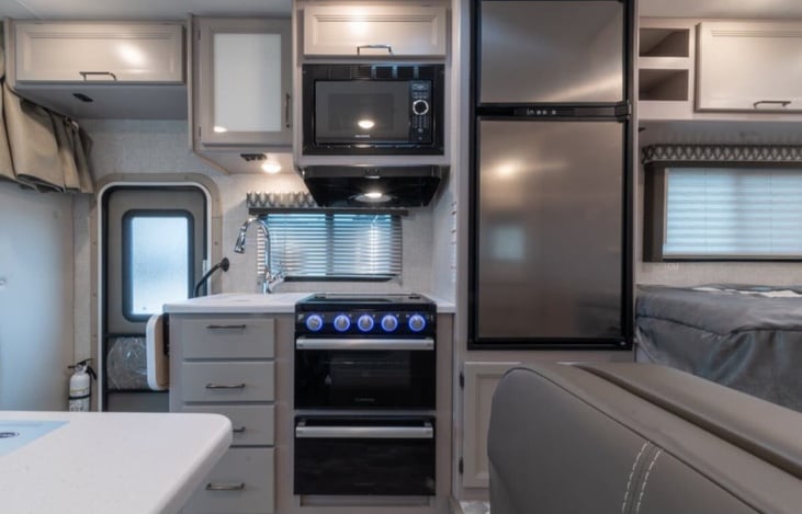 Gas stove and oven. Kitchen supplies stocked.