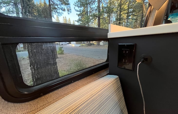 110v plugs and USB ports are conveniently located for charging devices.