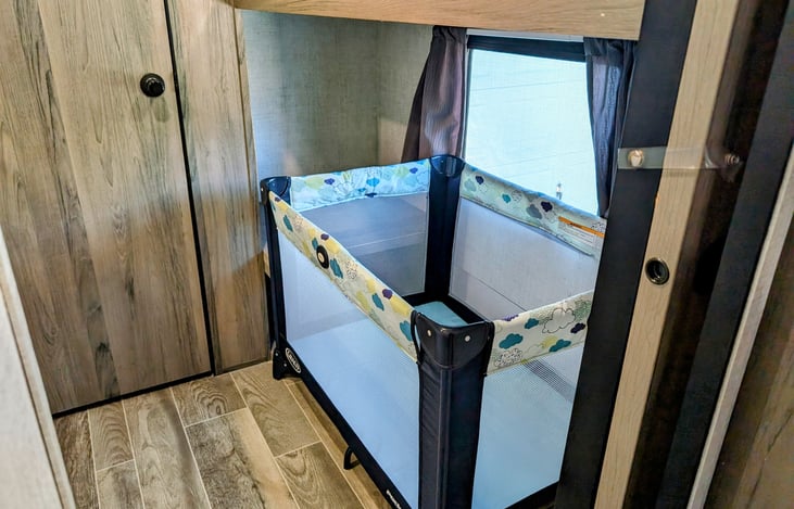 Additional storage under bunk, large enough to fit a Graco Pack n Play for baby!