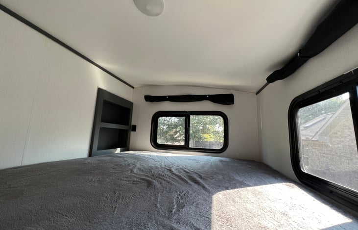 Top bunk space includes two windows with fold down curtains, light, small storage area, and two USB ports. Comfortably sleeps 1 adult or 2 children. 300lb MAX weight limit.