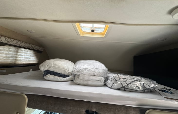 Upper bunk outfitted with additional memory foam topper for added comfort. bedding can be added as an add on.