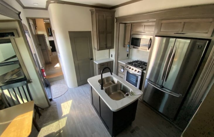 Kitchen with top-of-the-line stainless steel appliances: refrigerator, 30” Convection Microwave, dishwasher, 2 sinks.
Insert the table leaf to seat 5 comfortably.
Has its own central air conditioner.